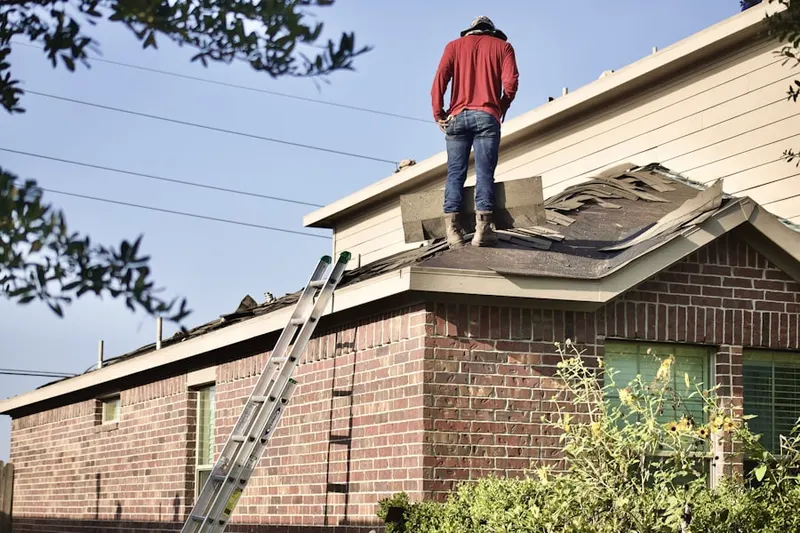Professional roofer working on a residential roof in Boylston Center